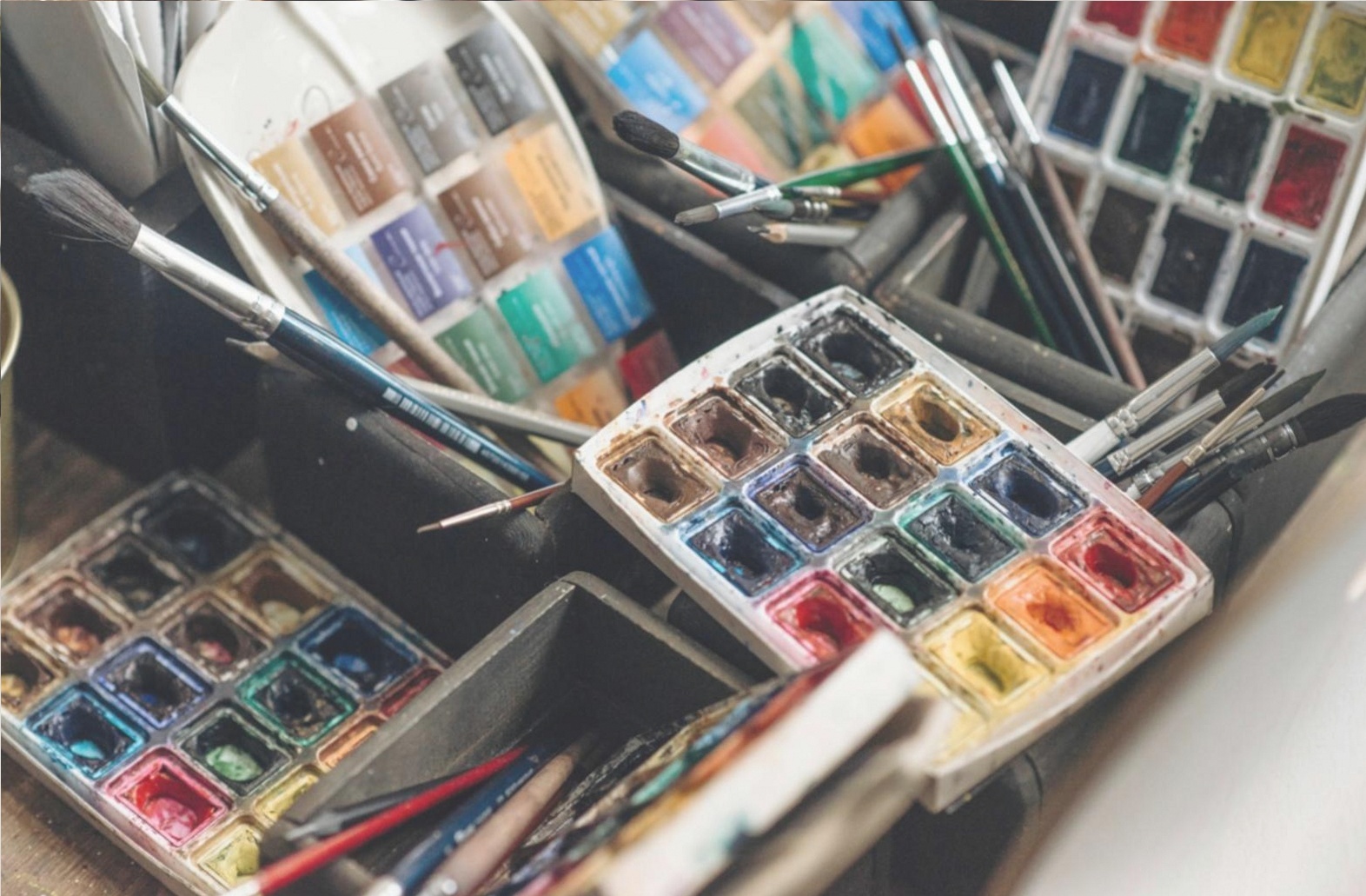 Concept art sketchbook and drawing tools on a studio desk